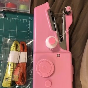 Pink hand held sewing machine
